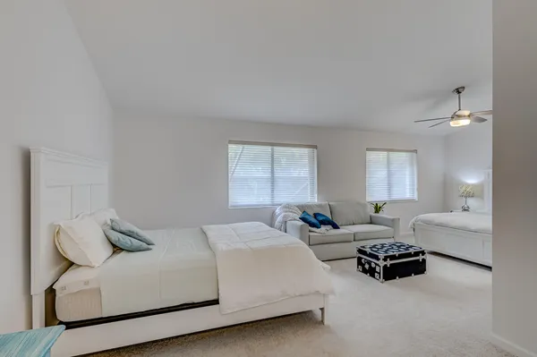 a bedroom with two beds and a chandelier
