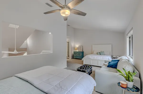 a bedroom with two beds and windows