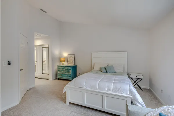 a bedroom with a bed and a large window