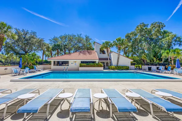a view of swimming pool with outdoor seating and yard in the back