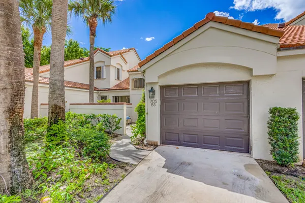 a kitchen with granite countertop white cabinets and stainless steel appliances