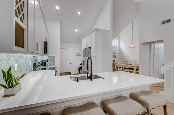 a kitchen with stainless steel appliances granite countertop a refrigerator and a stove