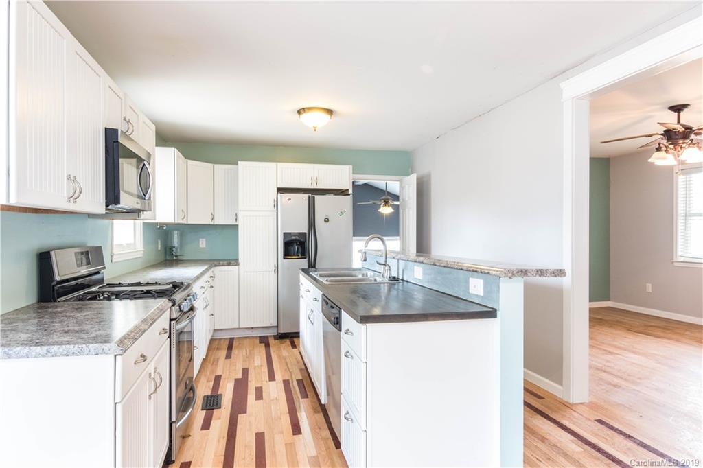 13800 Huntersville-Concord Road Huntersville, NC 28078 - Photo 2 of 16 a kitchen with a sink stove and refrigerator
