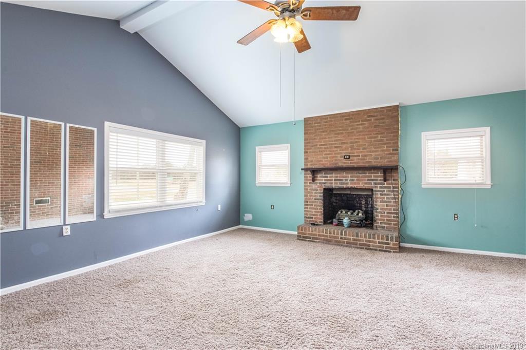 13800 Huntersville-Concord Road Huntersville, NC 28078 - Photo 11 of 16 an empty room with windows and fireplace