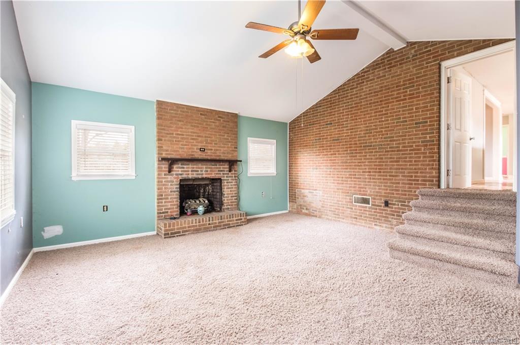 13800 Huntersville-Concord Road Huntersville, NC 28078 - Photo 12 of 16 a view of empty room with fireplace and fan