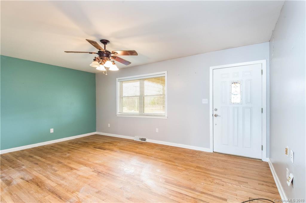 13800 Huntersville-Concord Road Huntersville, NC 28078 - Photo 4 of 16 a view of a room with a ceiling fan and a window