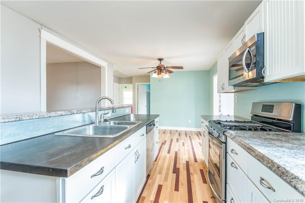 13800 Huntersville-Concord Road Huntersville, NC 28078 - Photo 10 of 16 a kitchen with a sink stove and cabinets
