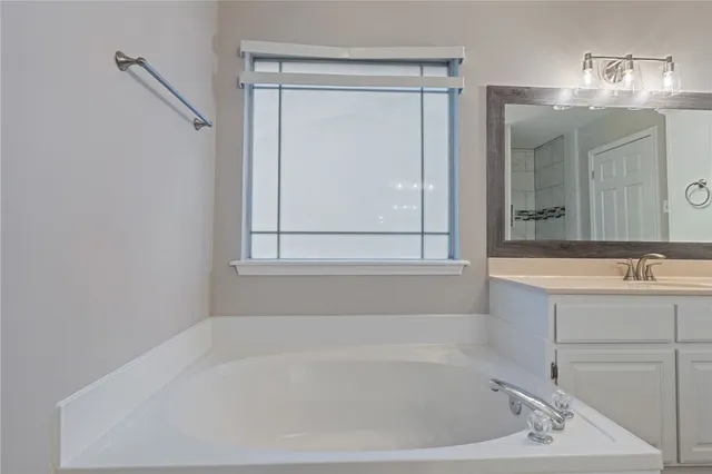 a bath tub sitting next to a bathroom sink