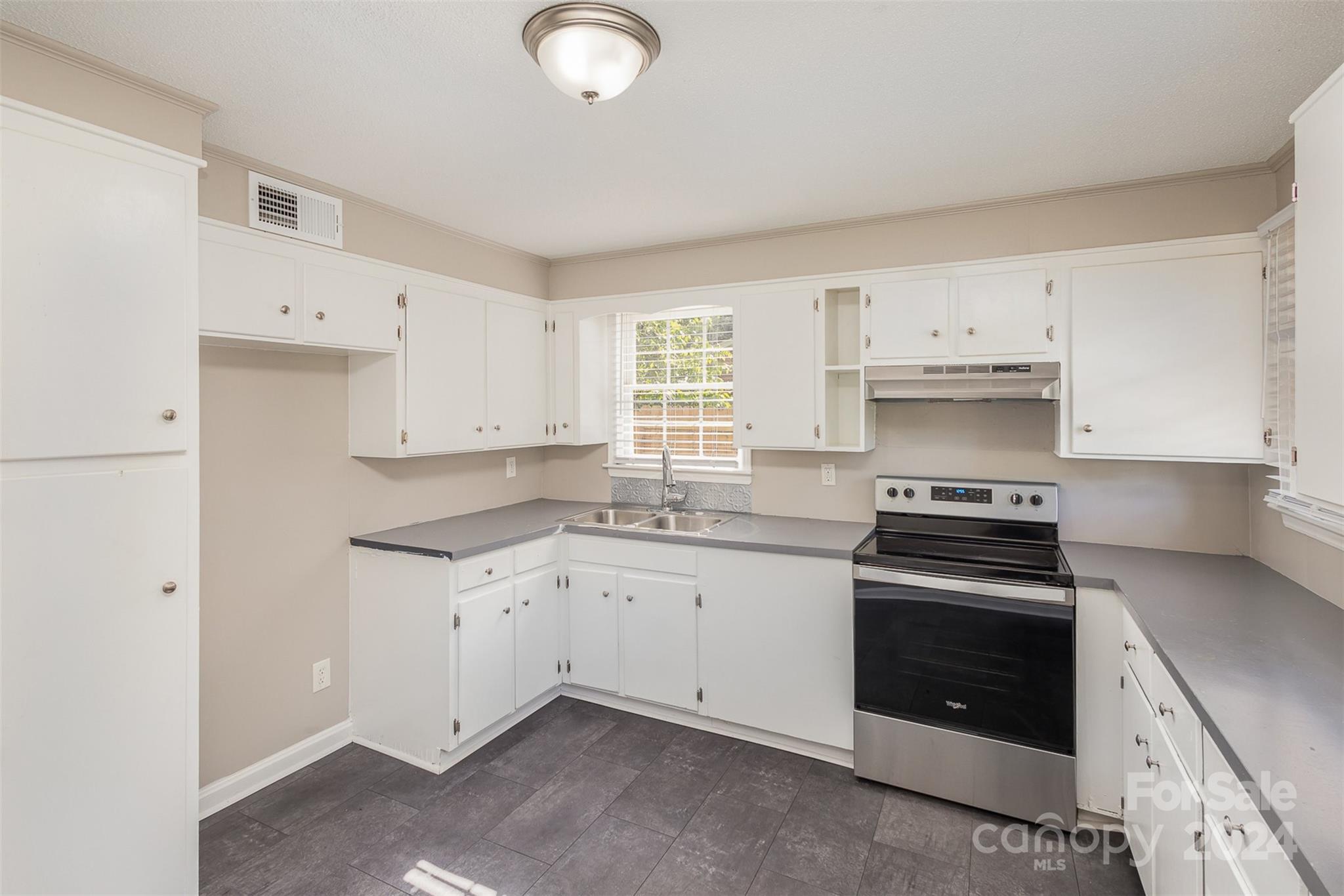 355 Sleepy Hollow Road Charlotte, NC 28217 - Photo 8 of 26 a kitchen with granite countertop a stove sink and dishwasher