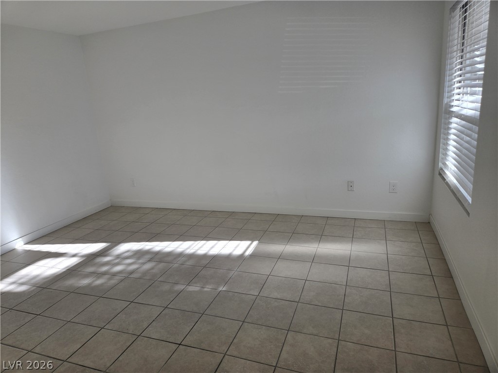 6250 West Flamingo Road, Unit 131 Las Vegas, NV 89103 - Photo 8 of 11 Well-lit room with durable tile flooring and natural light from window blinds.