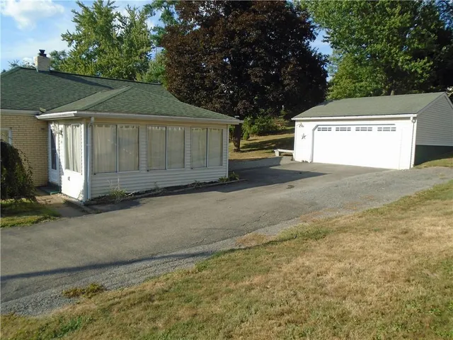 a view of a house with a yard and garage