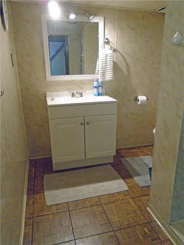 a view of a kitchen with wooden floor and a sink