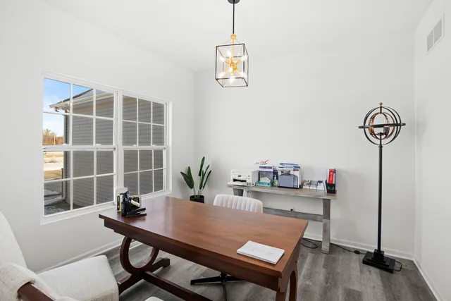 a view of a workspace with furniture