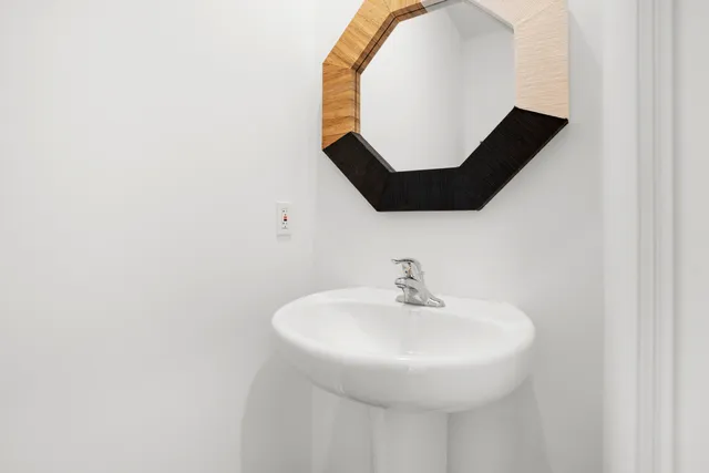 a bathroom with a sink and mirror