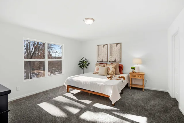 a bedroom with a bed and a large window