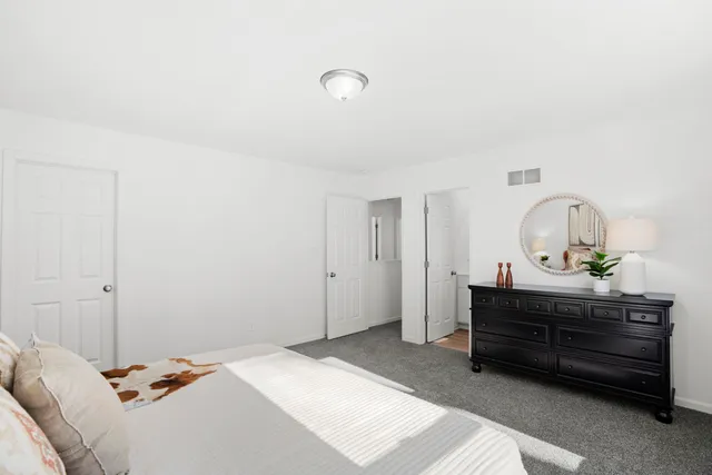 a bedroom with a bed and a dresser