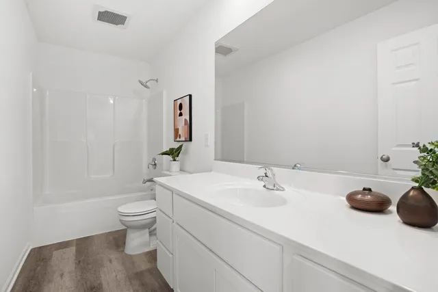 a bathroom with a sink a toilet and a tub