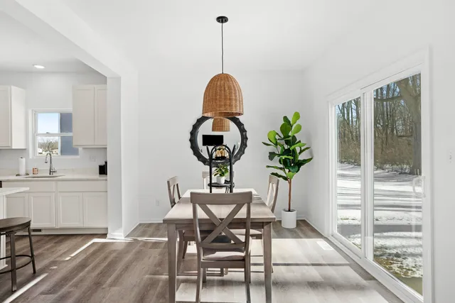a view of a dining room with furniture window and wooden floor