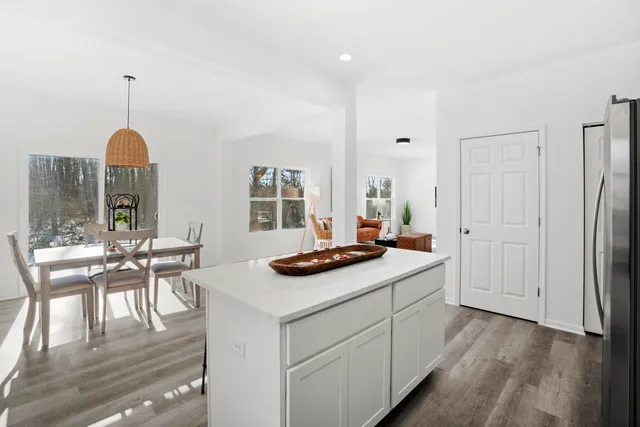 a kitchen with stainless steel appliances granite countertop a sink and a refrigerator
