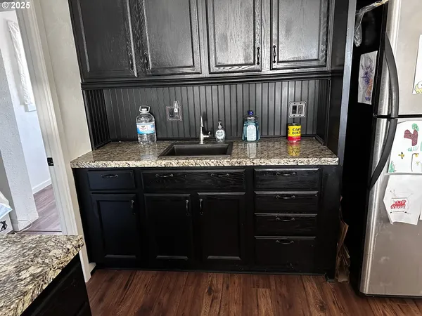 a kitchen with stainless steel appliances granite countertop a refrigerator and cabinets