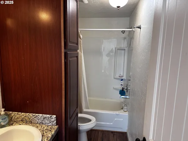 a bathroom with a sink toilet and shower