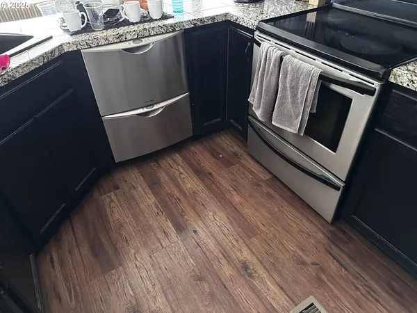 a view of washer and dryer with wooden floor