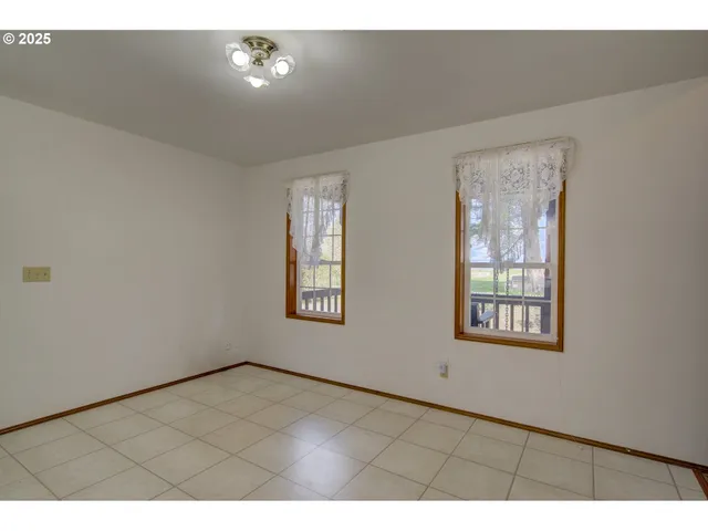 a living room with stainless steel appliances kitchen island granite countertop furniture and a large window