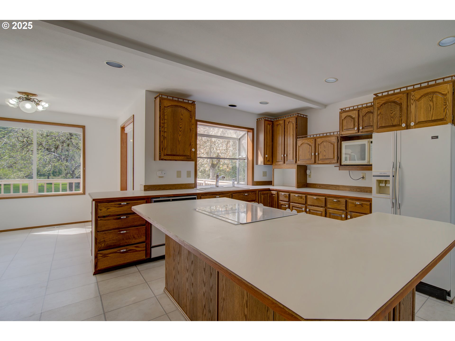 34009 Territory Road Oysterville, WA 98641 - Photo 17 of 39 a living room with stainless steel appliances kitchen island granite countertop furniture and a large window