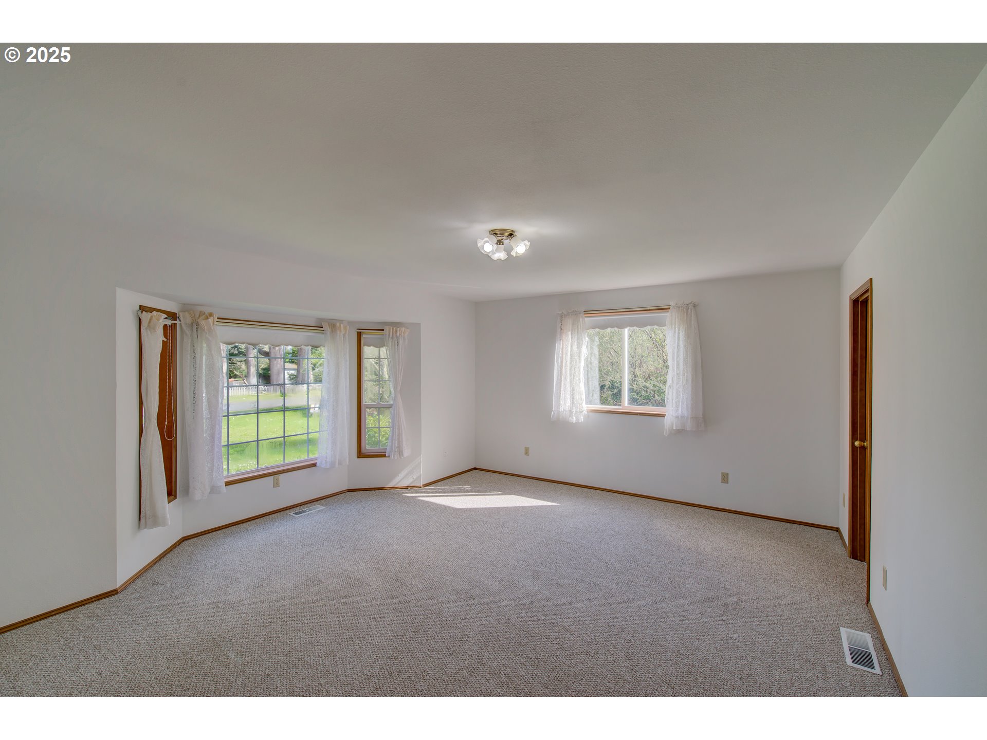 34009 Territory Road Oysterville, WA 98641 - Photo 21 of 39 a view of an empty room with a window