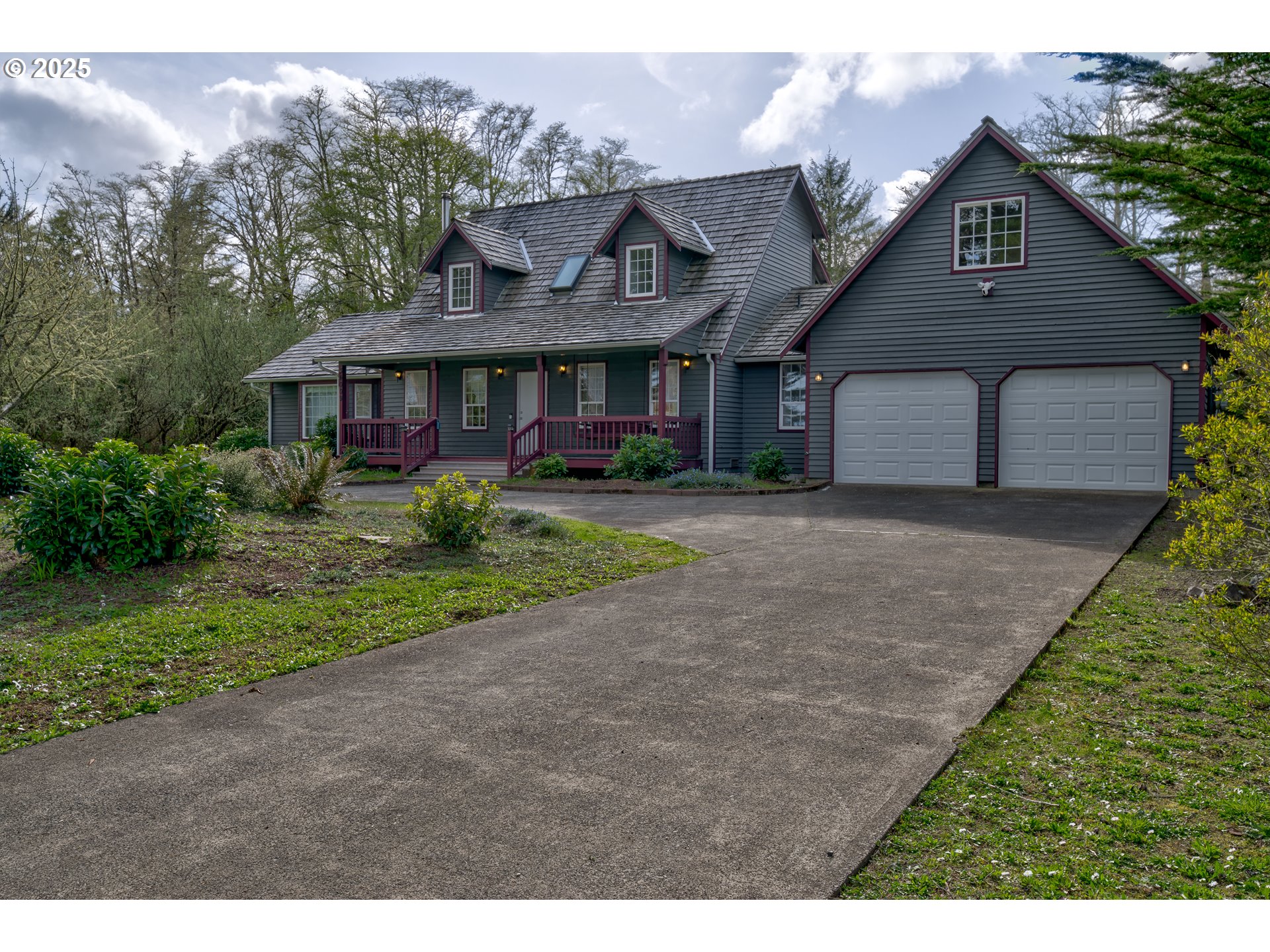 34009 Territory Road Oysterville, WA 98641 - Photo 5 of 39 a front view of a house with a yard and garage