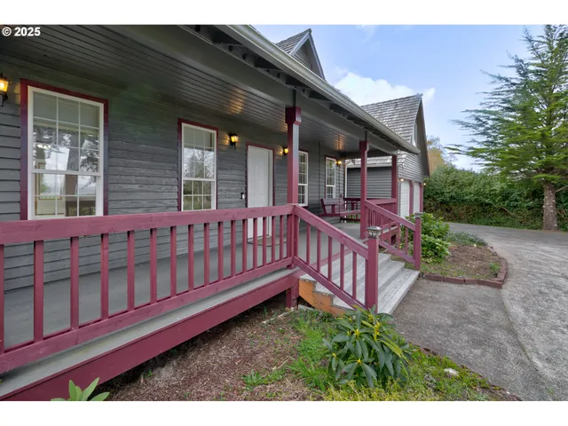 a view of a house with wooden deck and furniture