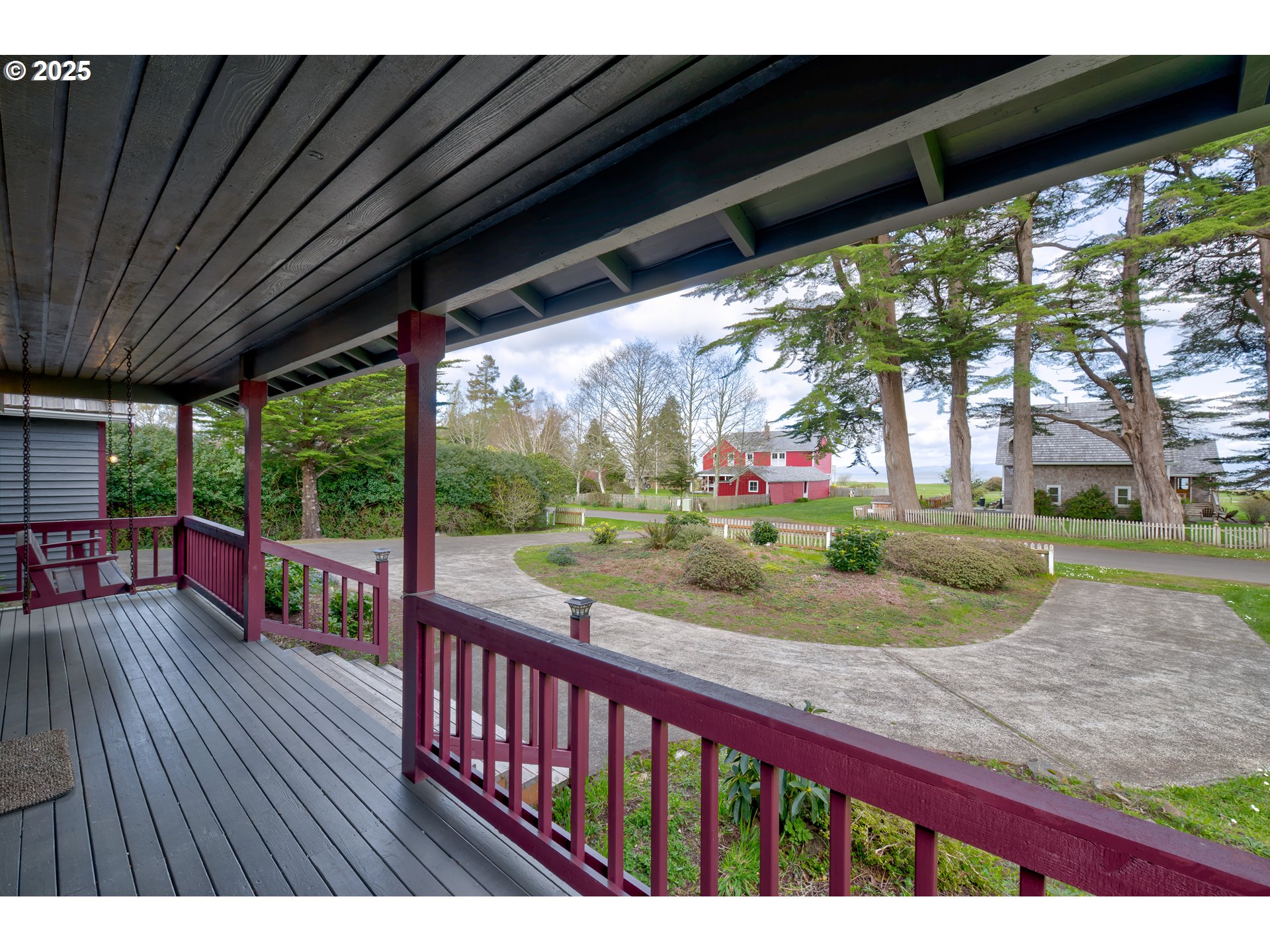 34009 Territory Road Oysterville, WA 98641 - Photo 10 of 39 a view of a porch with wooden floor and outdoor space