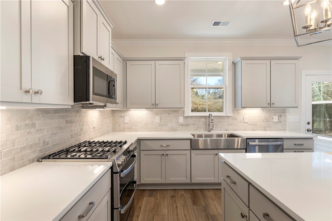 707 Weathered Oak Way Anderson, SC 29621 - Photo 11 of 28 This bright kitchen features elegant cabinetry, modern appliances, and a convenient center island.