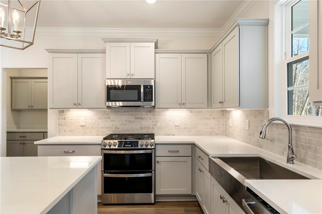 707 Weathered Oak Way Anderson, SC 29621 - Photo 12 of 28 This contemporary kitchen features bright cabinetry, modern appliances, and ample counter space.