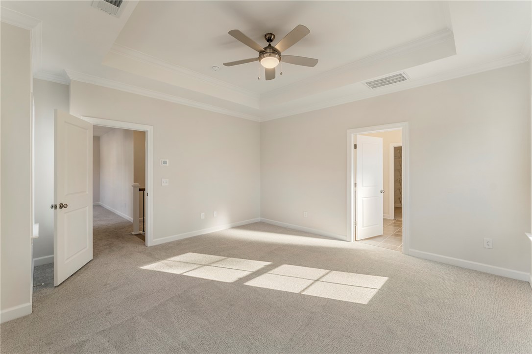 707 Weathered Oak Way Anderson, SC 29621 - Photo 14 of 28 This spacious bedroom offers ample natural light and a tray ceiling with a fan for comfort.