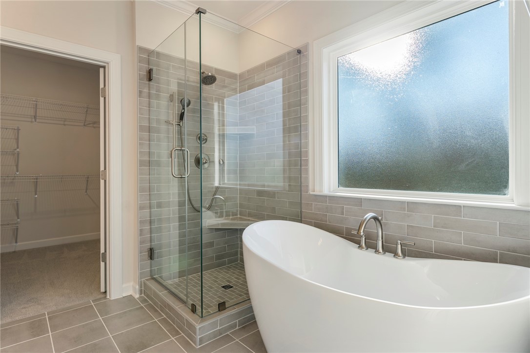707 Weathered Oak Way Anderson, SC 29621 - Photo 15 of 28 Relax and refresh in this tranquil bathroom, featuring a sleek soaking tub and spacious shower.