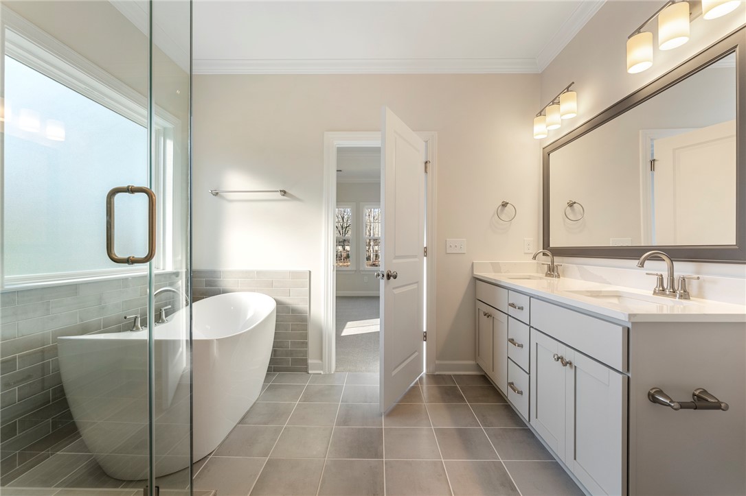 707 Weathered Oak Way Anderson, SC 29621 - Photo 16 of 28 This spacious bathroom offers a double vanity and a luxurious soaking tub for ultimate comfort.