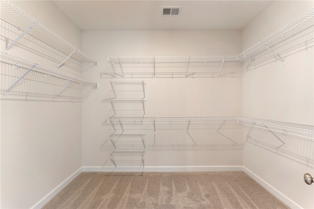707 Weathered Oak Way Anderson, SC 29621 - Photo 17 of 28 This spacious walk-in closet features ample wire shelving and plush carpet flooring.