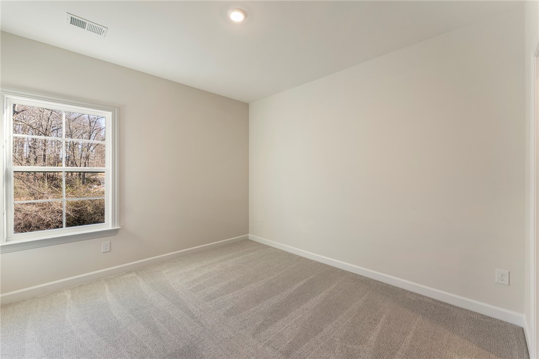 707 Weathered Oak Way Anderson, SC 29621 - Photo 20 of 28 This spacious room offers comfort with carpet flooring and ample natural light.