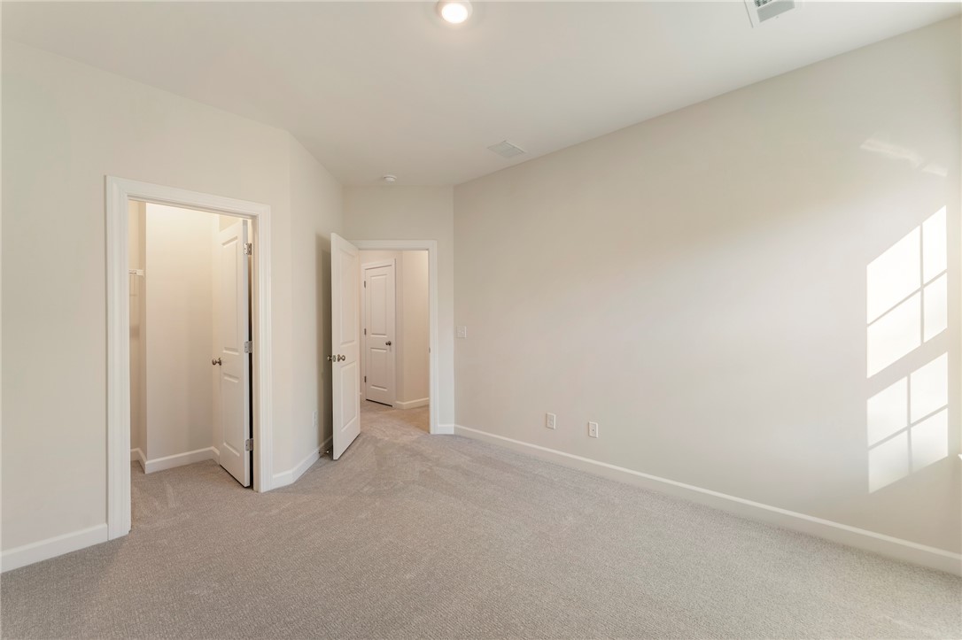 707 Weathered Oak Way Anderson, SC 29621 - Photo 21 of 28 This spacious room offers comfort and versatility, featuring soft carpet flooring and ample natural light.