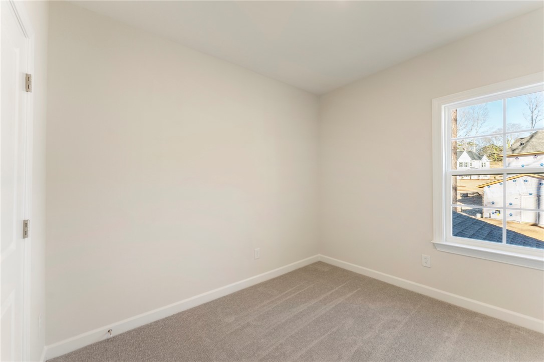 707 Weathered Oak Way Anderson, SC 29621 - Photo 22 of 28 This bright room features natural light and neutral carpeting.