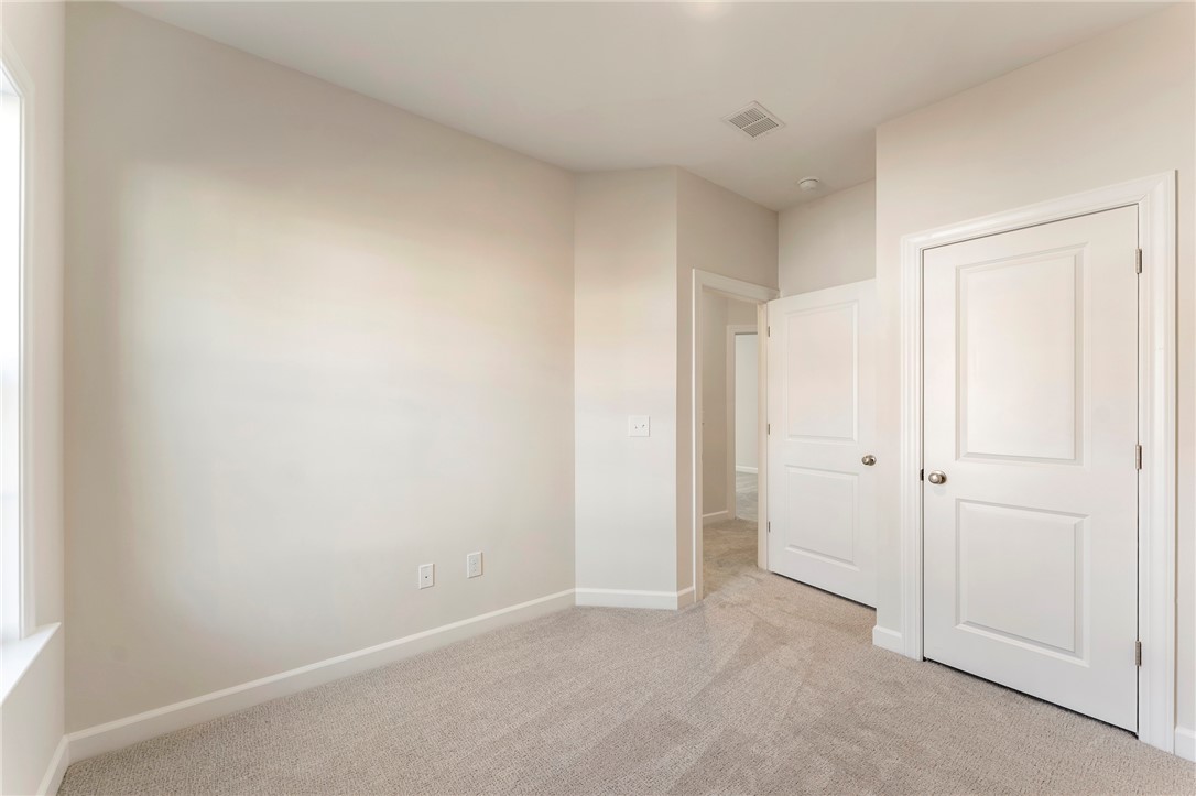 707 Weathered Oak Way Anderson, SC 29621 - Photo 23 of 28 This bright and airy room features soft carpeting, a window, and multiple paneled doors.