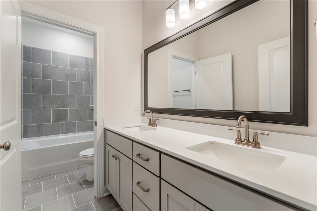 707 Weathered Oak Way Anderson, SC 29621 - Photo 24 of 28 This sleek bathroom features a spacious dual vanity and a tiled shower-tub combo.