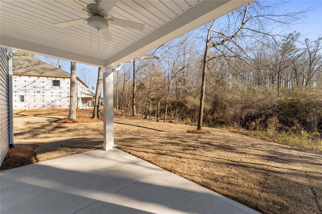707 Weathered Oak Way Anderson, SC 29621 - Photo 27 of 28 This covered patio offers a serene outdoor space, perfect for enjoying the surrounding natural landscape.
