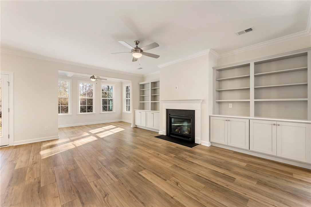 707 Weathered Oak Way Anderson, SC 29621 - Photo 4 of 28 This bright living space features elegant flooring and built-in shelving, offering both comfort and style.