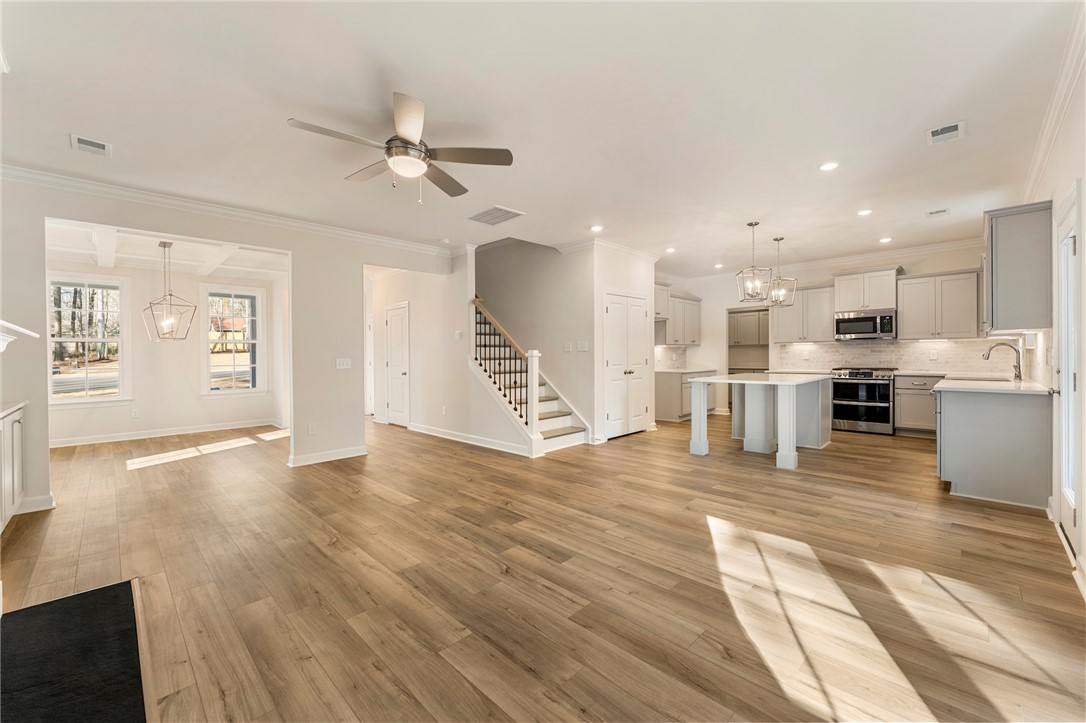 707 Weathered Oak Way Anderson, SC 29621 - Photo 7 of 28 This open concept living space features a modern kitchen and inviting dining area.