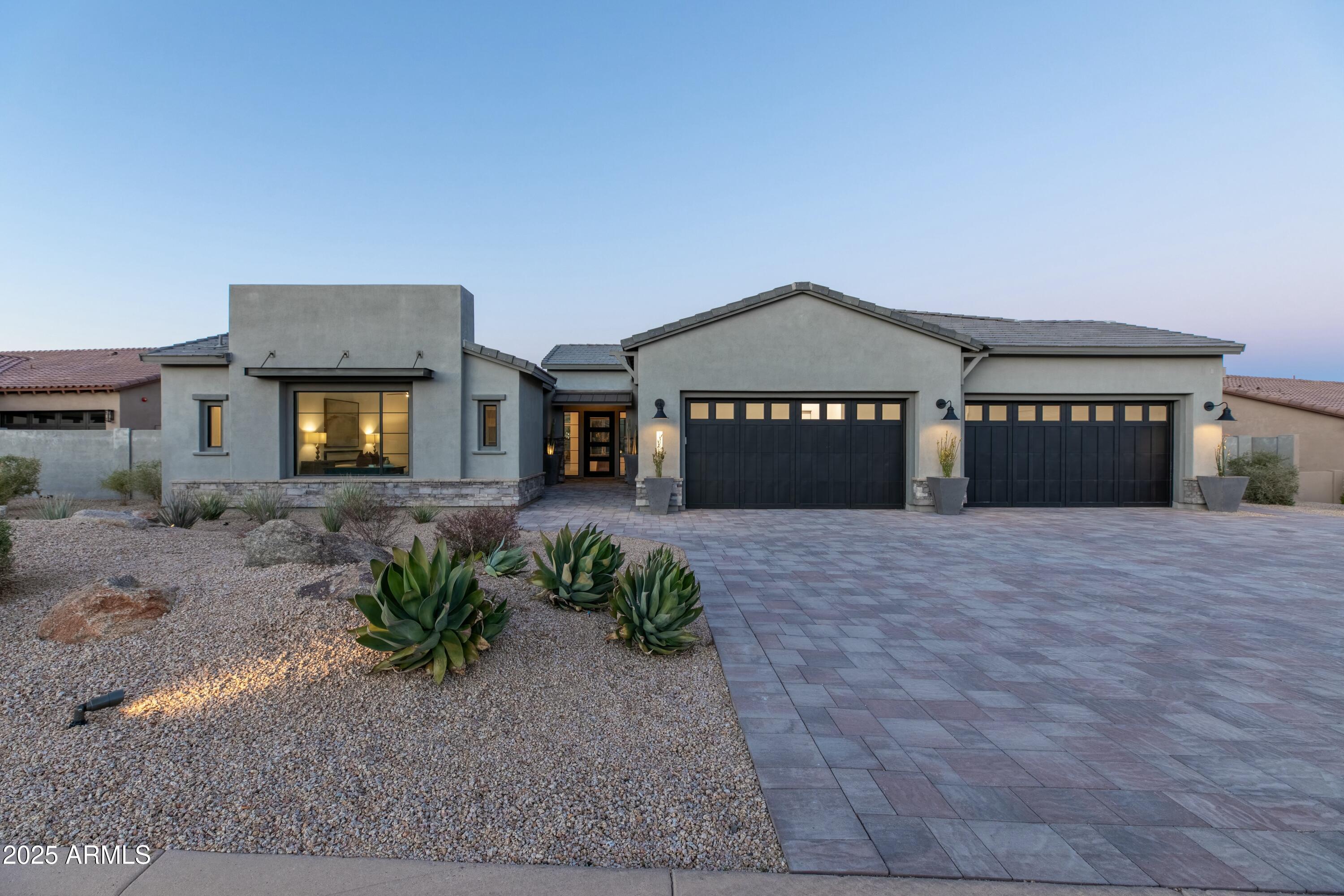a front view of a house with a yard and a garage