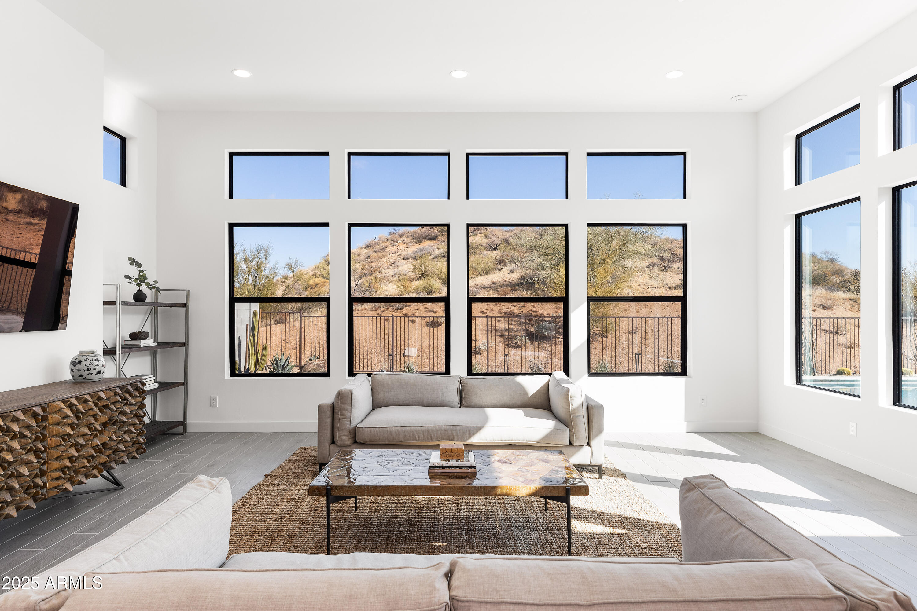 13238 East Ranch Gate Road Scottsdale, AZ 85255 - Photo 19 of 66 a living room with furniture large windows and a flat screen tv
