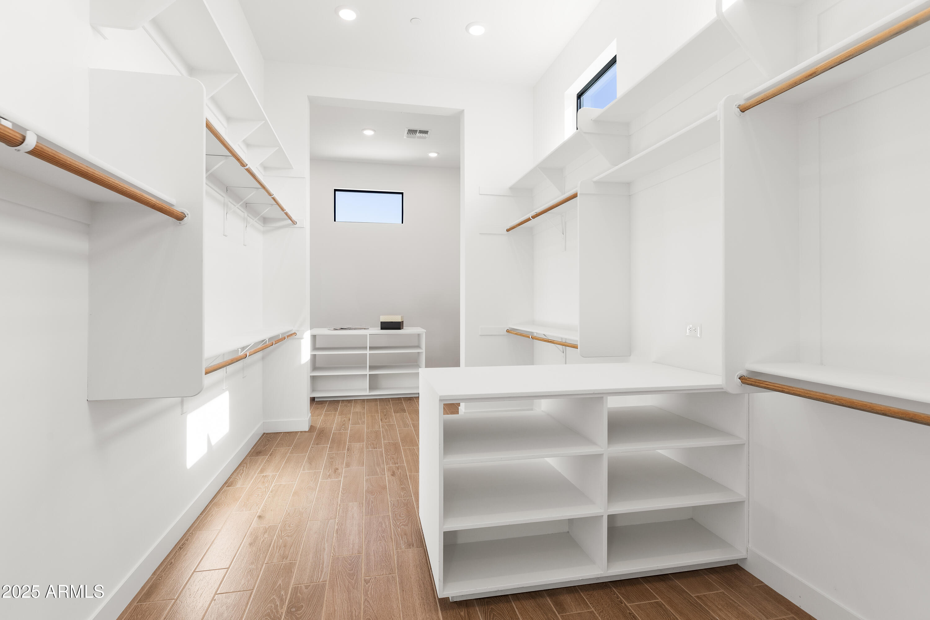 13238 East Ranch Gate Road Scottsdale, AZ 85255 - Photo 32 of 66 a view of walk in closet with wooden floor and cabinet