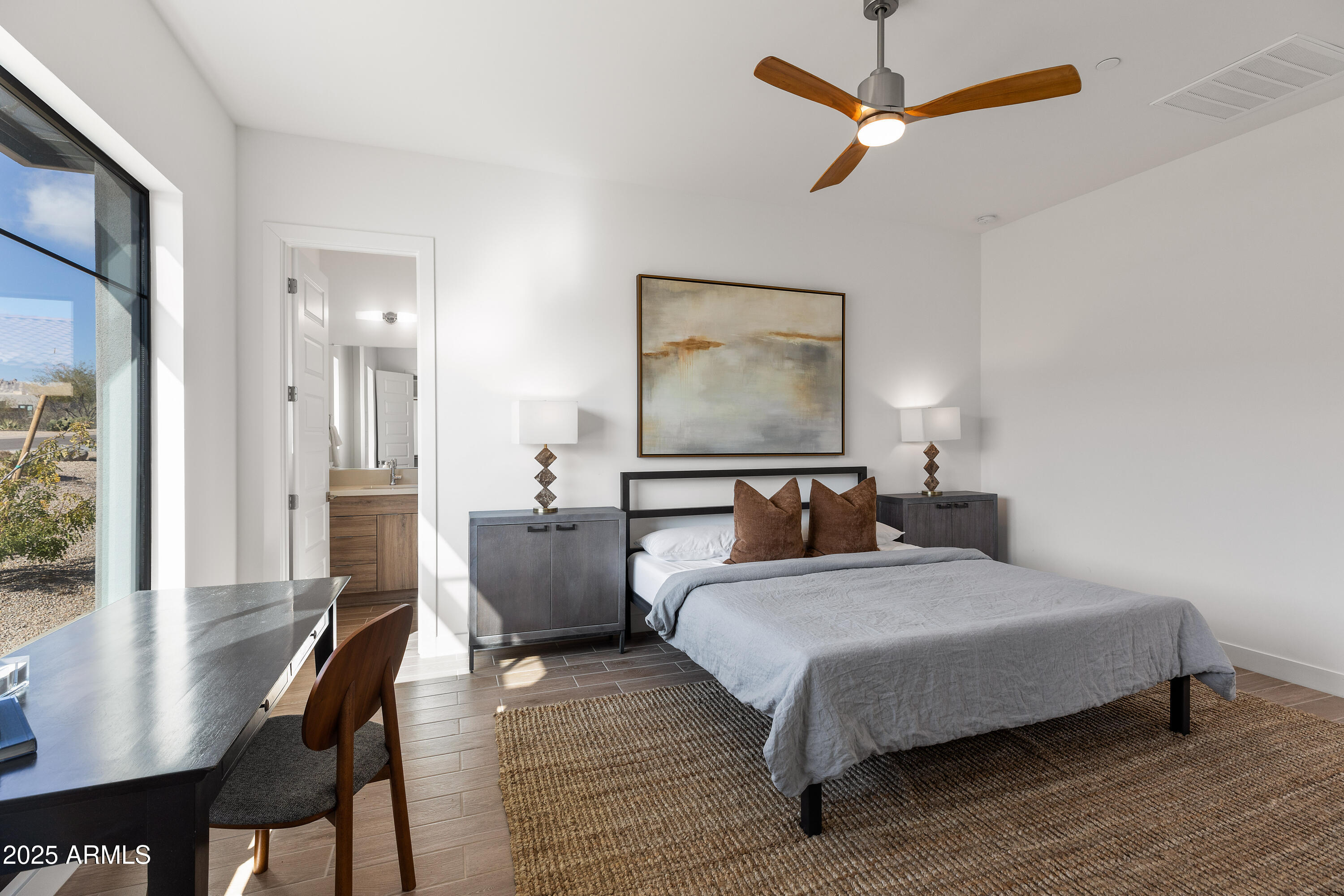 13238 East Ranch Gate Road Scottsdale, AZ 85255 - Photo 43 of 66 a bedroom with a bed and wooden floor